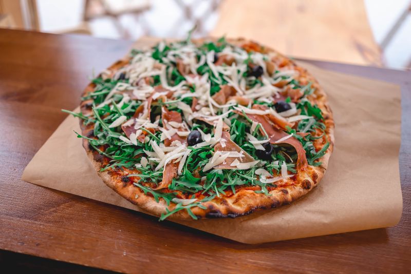 Veggie punch pizza with colorful seasonal vegetables and goat cheese